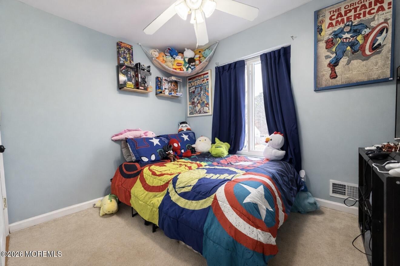 15 Commodore Court Barnegat, NJ 08005 - Photo 10 of 19 a bedroom with a bed and a chandelier