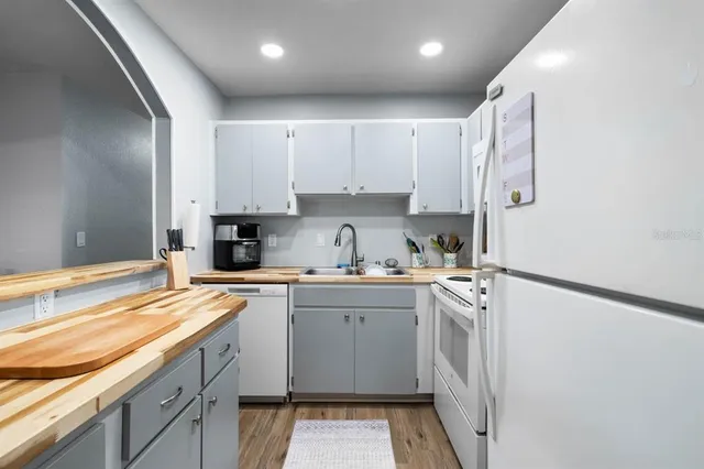 a kitchen with stainless steel appliances granite countertop a sink and cabinets
