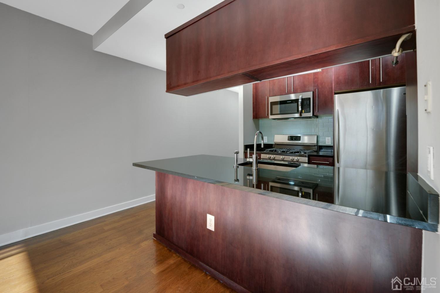301 Hudson Park Edgewater, NJ 07020 - Photo 12 of 44 a kitchen with stainless steel appliances a refrigerator a stove a sink and a oven