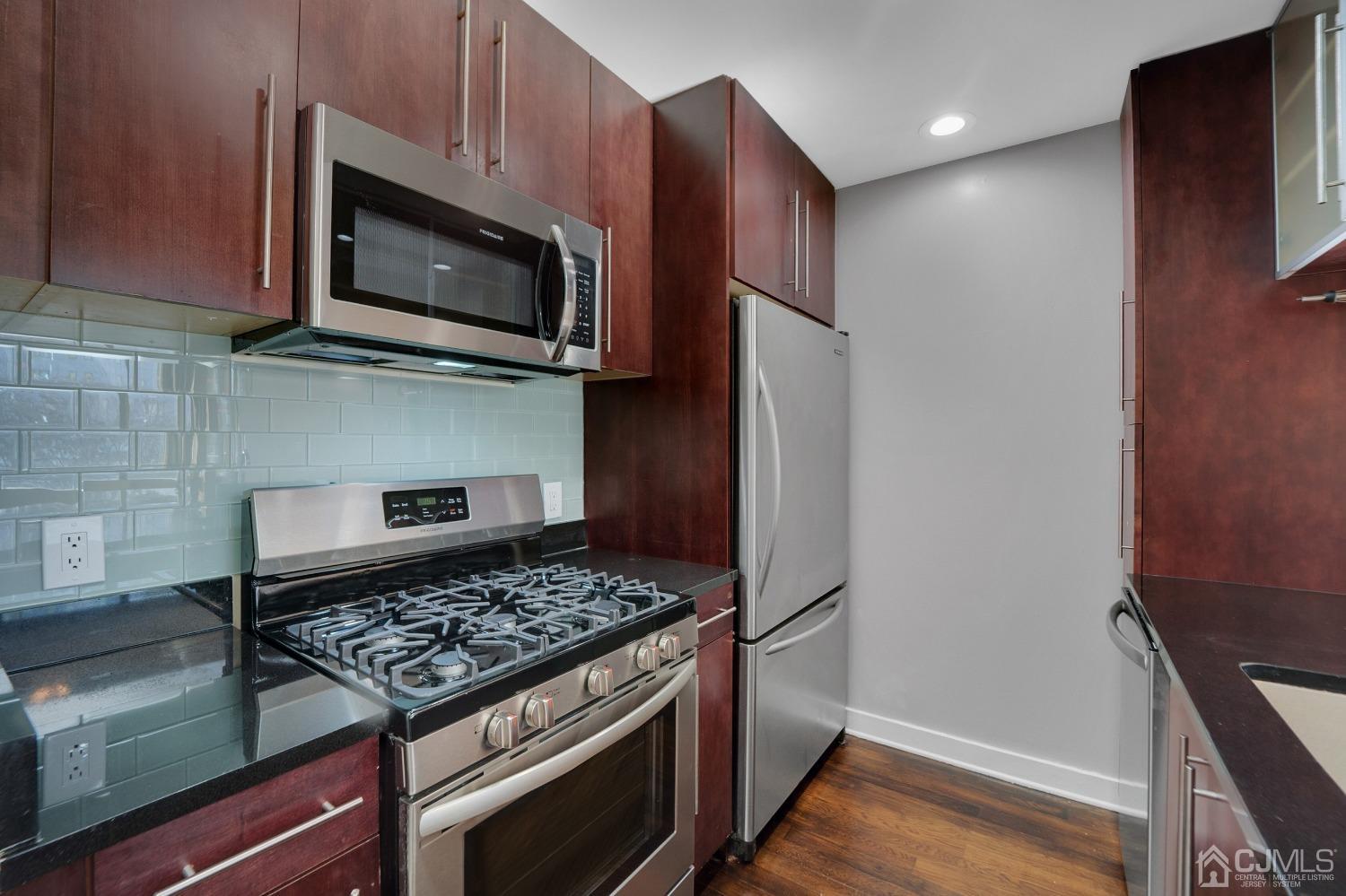 301 Hudson Park Edgewater, NJ 07020 - Photo 13 of 44 a kitchen with a stove and a microwave