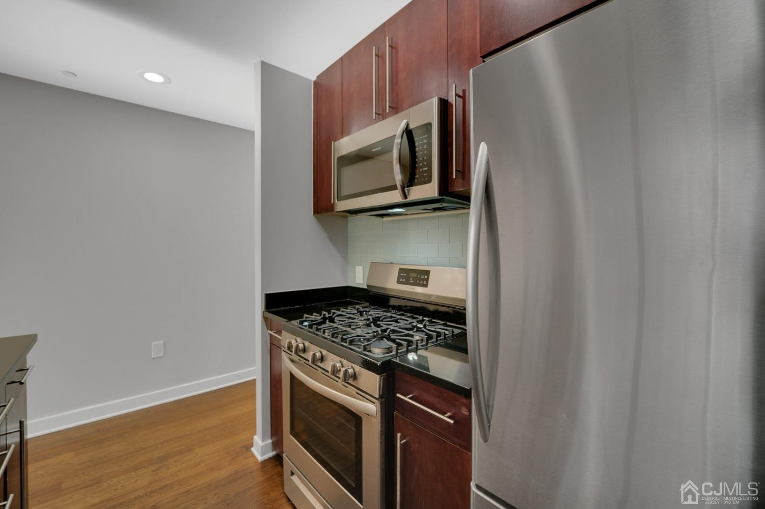301 Hudson Park Edgewater, NJ 07020 - Photo 15 of 44 a kitchen with stainless steel appliances granite countertop a stove and a microwave