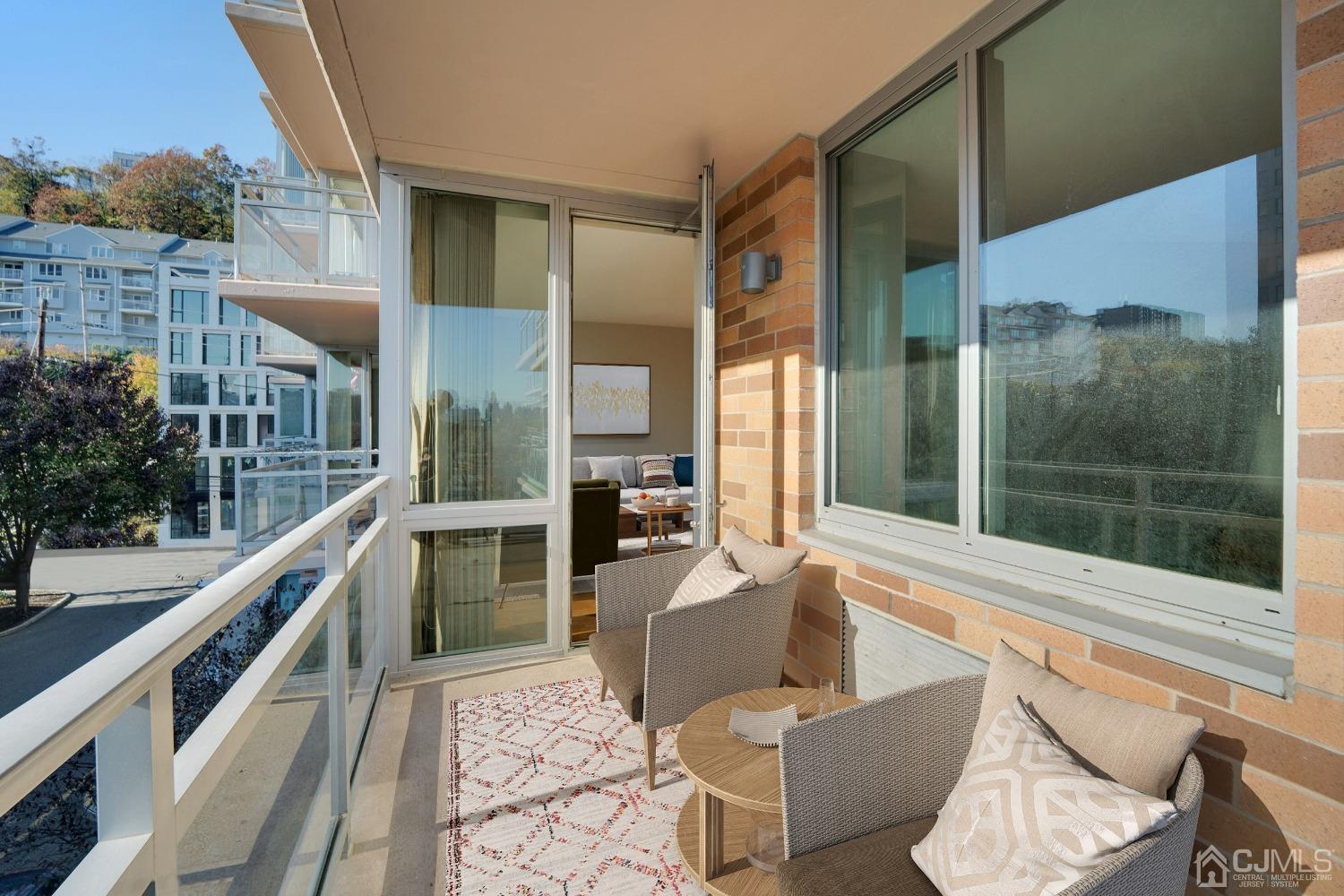 301 Hudson Park Edgewater, NJ 07020 - Photo 16 of 44 a balcony with table and chairs