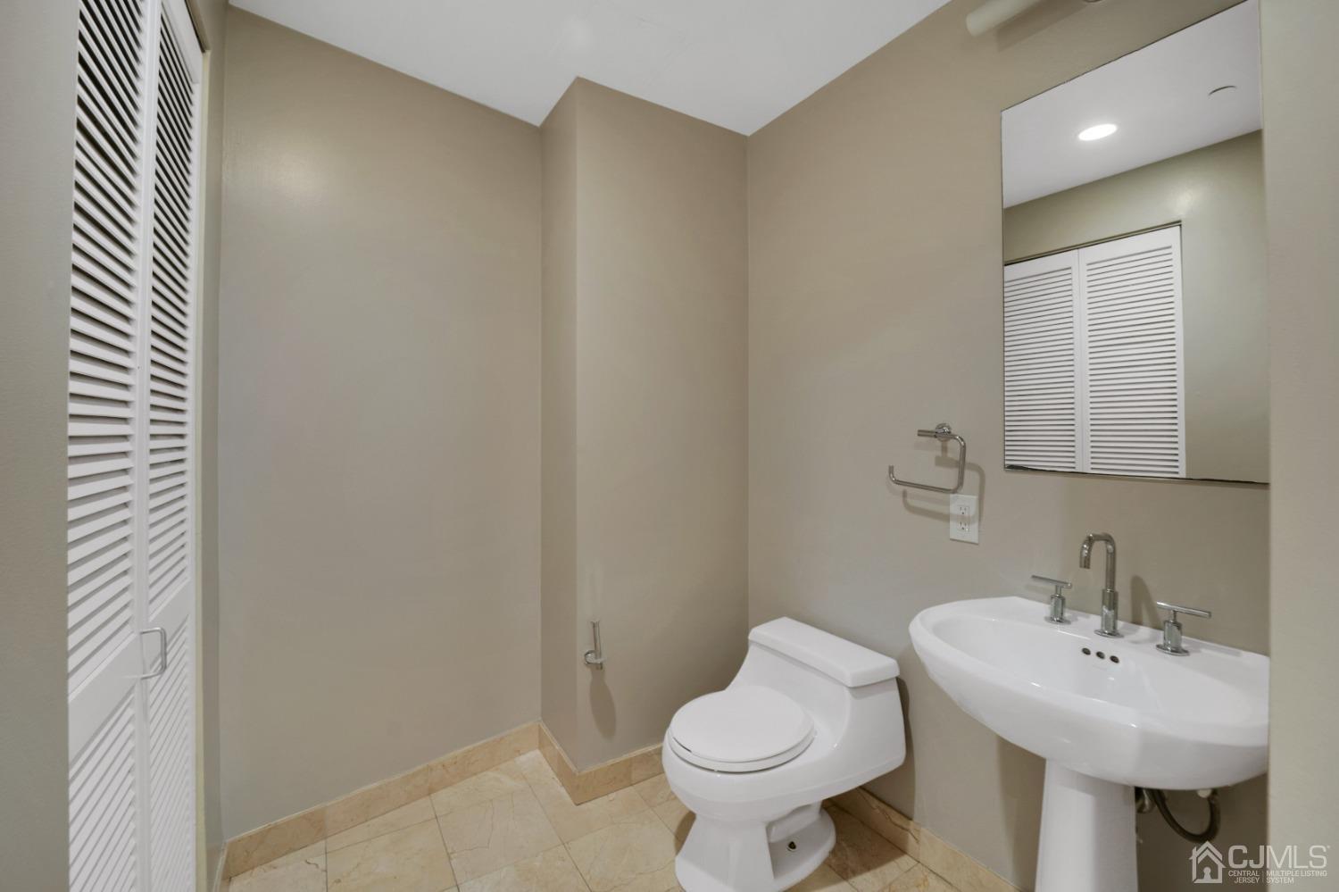 301 Hudson Park Edgewater, NJ 07020 - Photo 21 of 44 a bathroom with a sink and a toilet