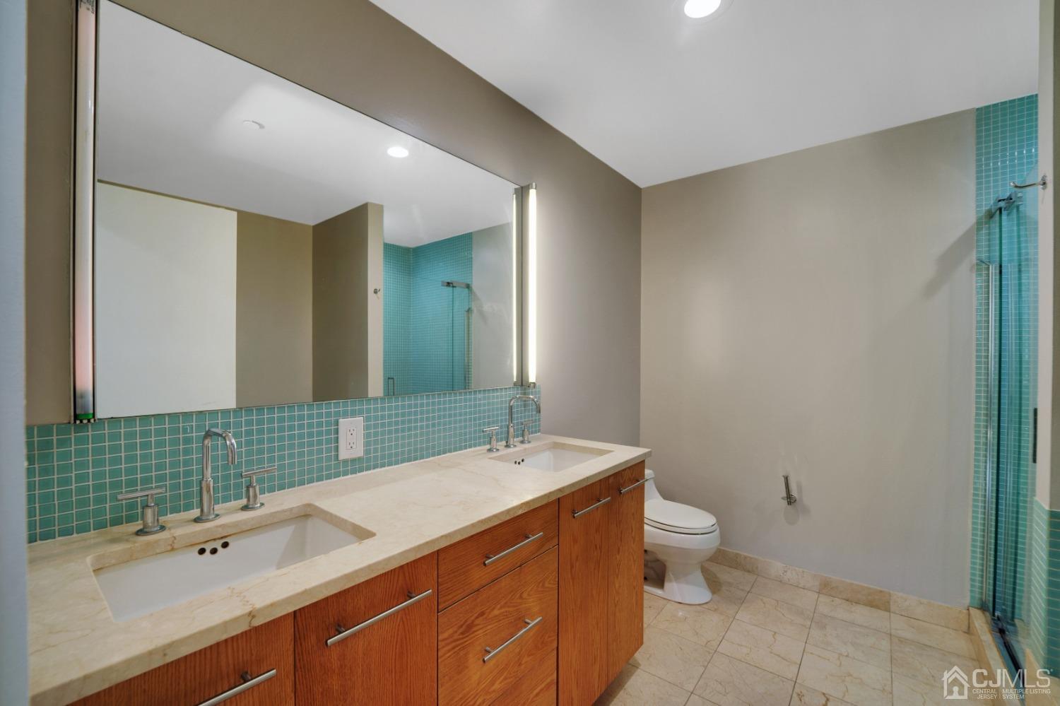 301 Hudson Park Edgewater, NJ 07020 - Photo 28 of 44 a bathroom with a sink and a mirror