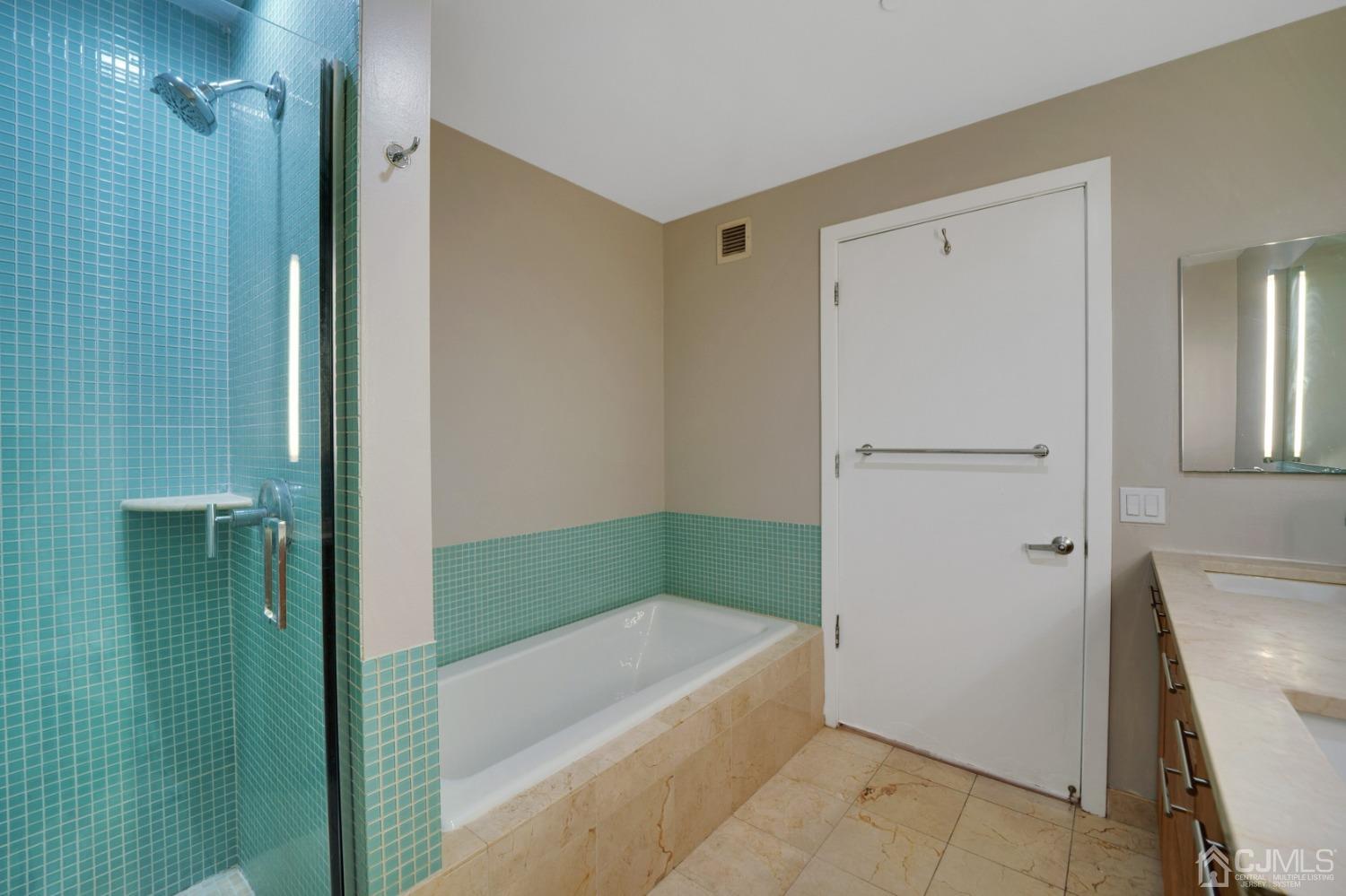 301 Hudson Park Edgewater, NJ 07020 - Photo 29 of 44 a bathroom with a bathtub and a shower
