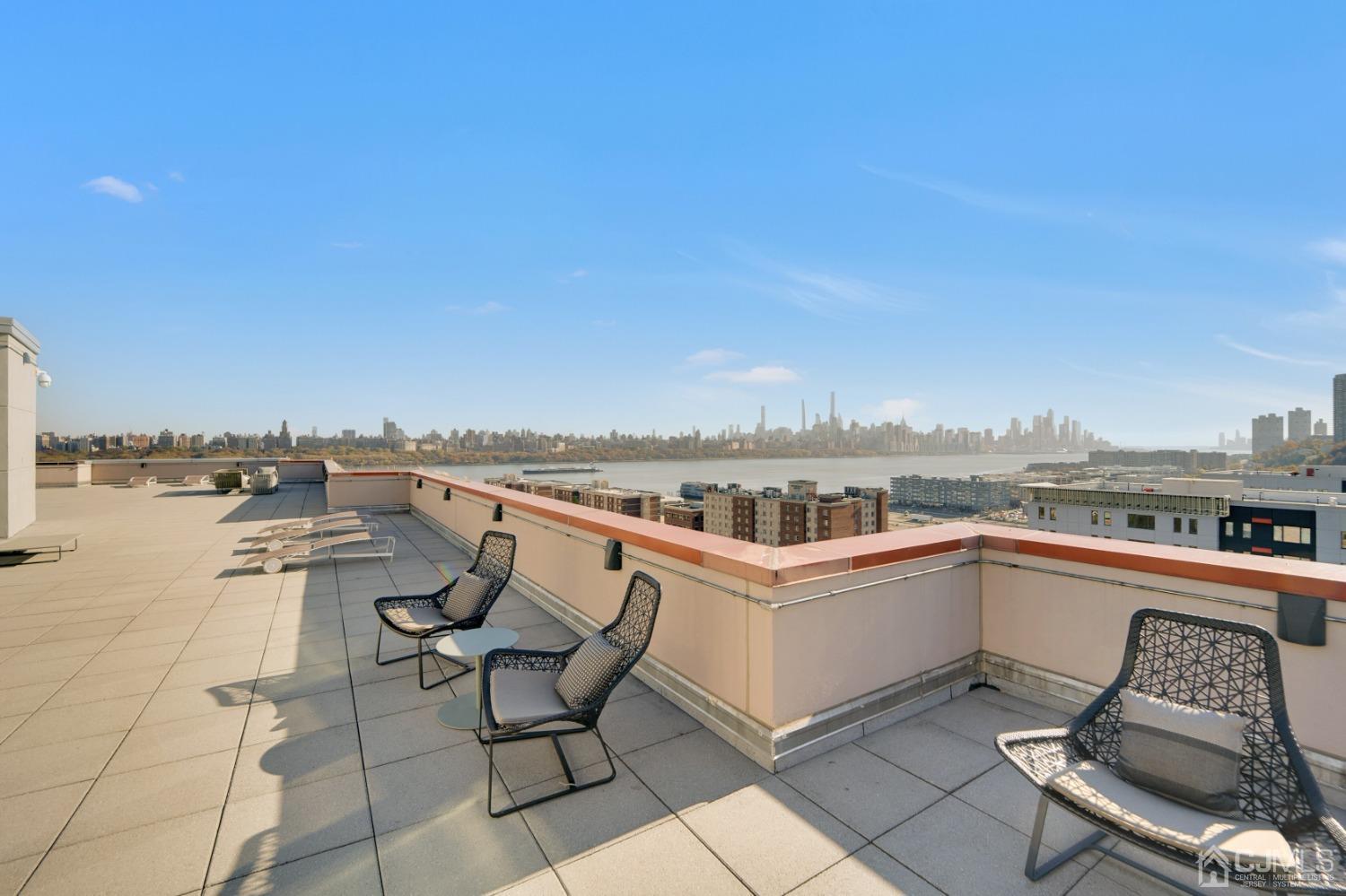 301 Hudson Park Edgewater, NJ 07020 - Photo 39 of 44 a view of a terrace with lawn chairs and wooden fence