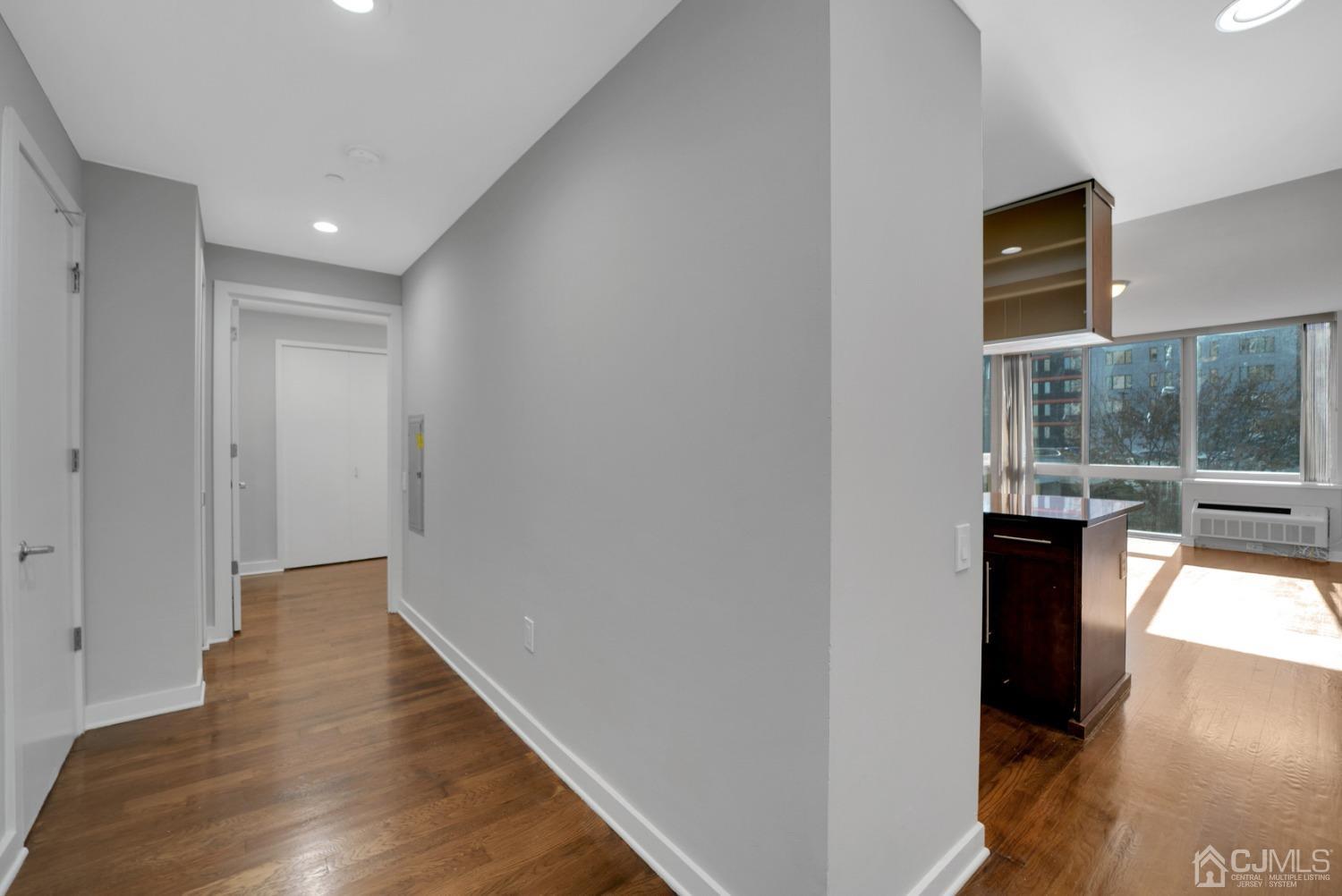301 Hudson Park Edgewater, NJ 07020 - Photo 8 of 44 a view of a hallway with wooden floor and a room