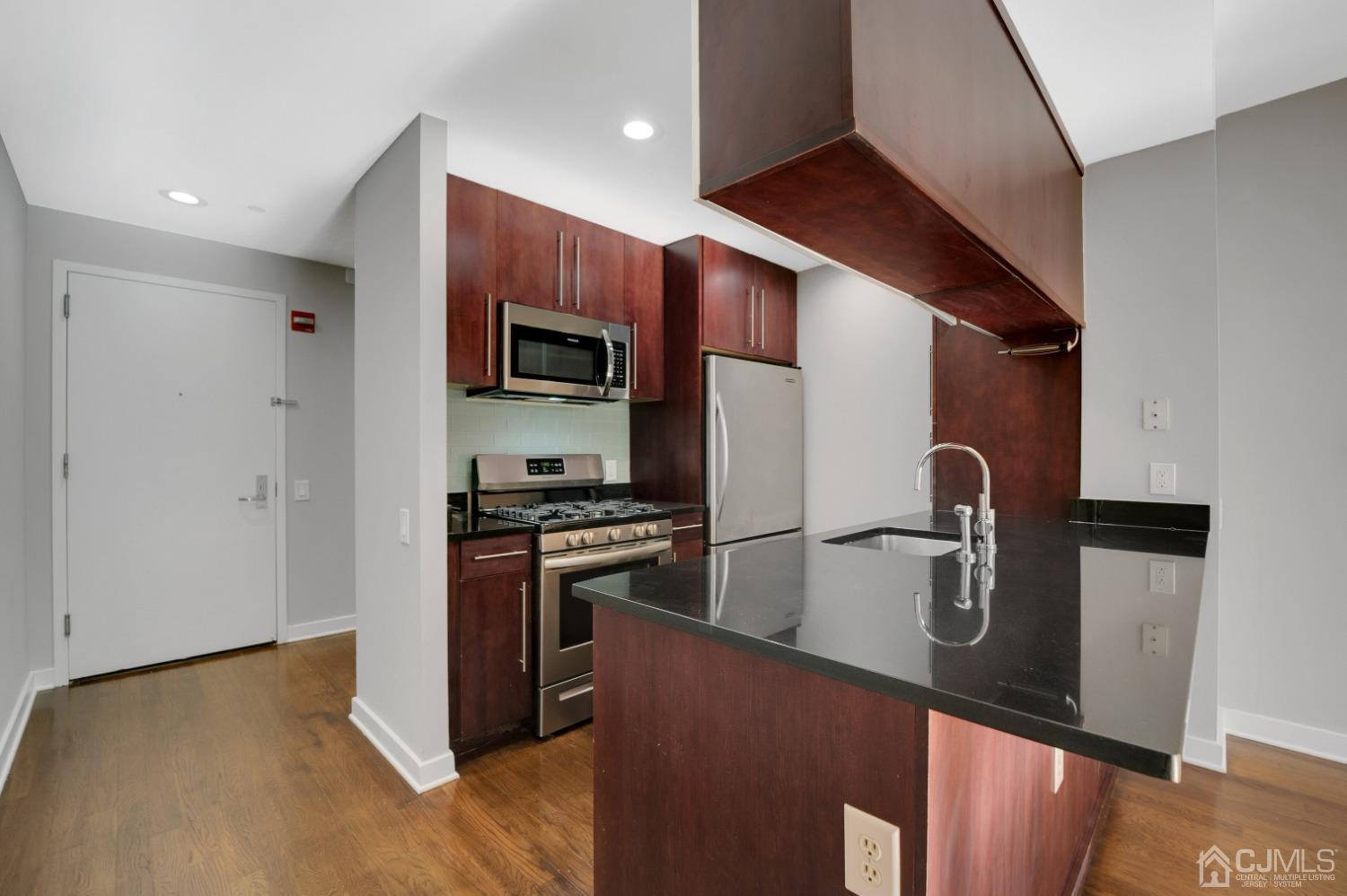 301 Hudson Park Edgewater, NJ 07020 - Photo 10 of 44 a kitchen with stainless steel appliances granite countertop a refrigerator a stove a sink and a microwave