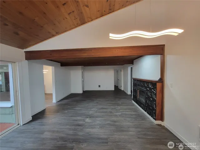a view of a livingroom with wooden floor and a ceiling fan