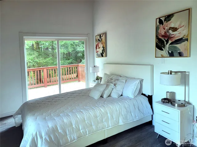 a bedroom with a large bed and a window