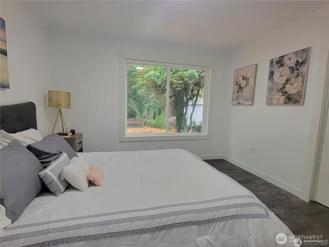 a bedroom with a bed and a window with the outer view