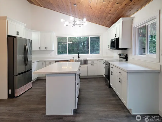 a kitchen with a sink stove and refrigerator