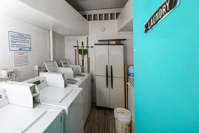 a kitchen with a refrigerator and a sink