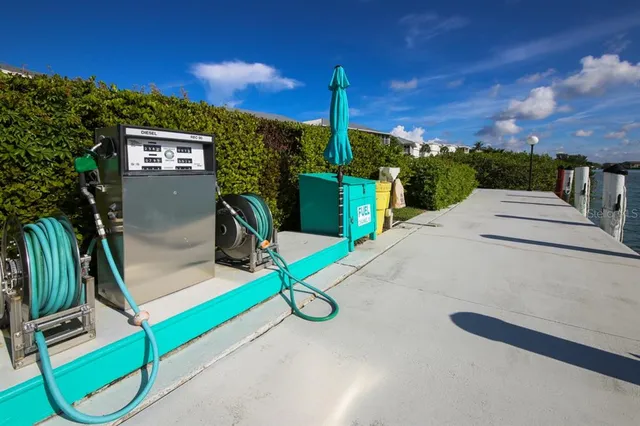 an aerial view of a residential houses with outdoor space and a lake view