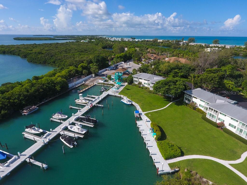 5820 Gasparilla Road, Unit SLIP 29 Boca Grande, FL 33921 - Photo 18 of 22 an aerial view of a residential houses with outdoor space and a lake view