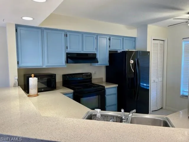 a kitchen with a refrigerator stove and cabinets
