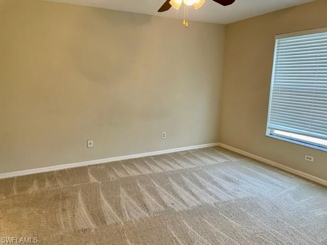 9580 Victoria Lane, Unit A202 Naples, FL 34109 - Photo 12 of 18 a view of an empty room with a window