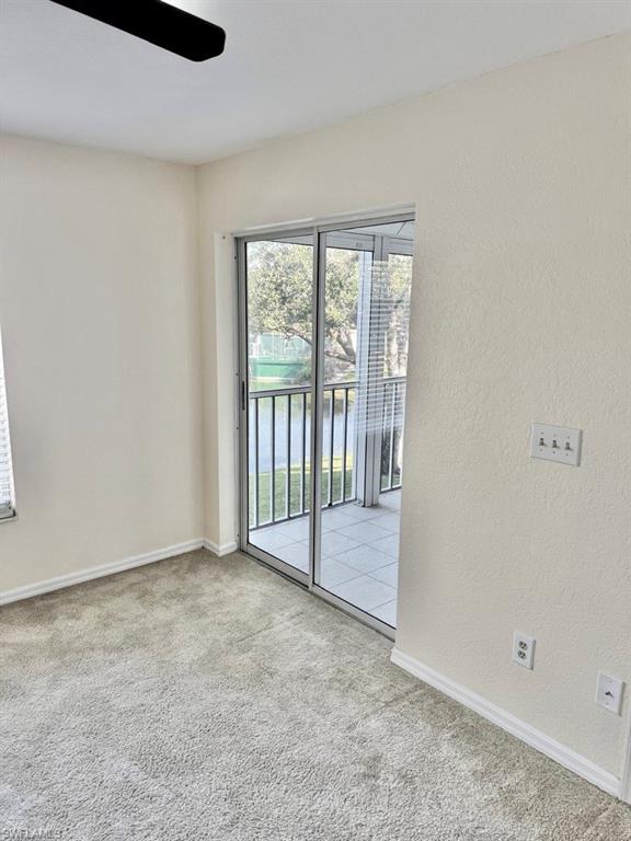 9580 Victoria Lane, Unit A202 Naples, FL 34109 - Photo 14 of 18 an empty room with sliding door