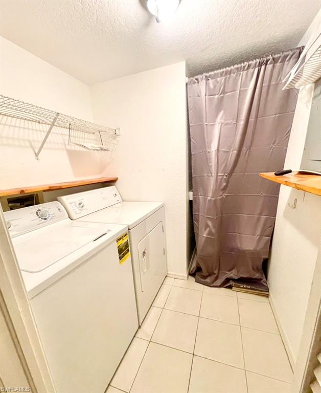 9580 Victoria Lane, Unit A202 Naples, FL 34109 - Photo 16 of 18 a utility room with dryer and washer