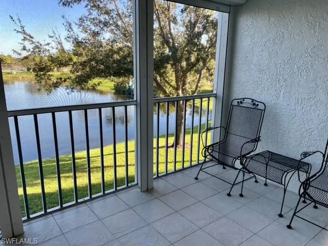 a view of a balcony with furniture and floor to ceiling window