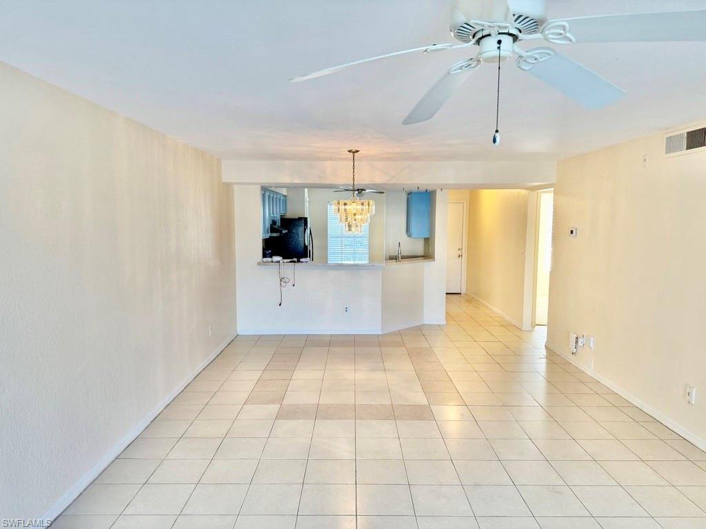 9580 Victoria Lane, Unit A202 Naples, FL 34109 - Photo 3 of 18 a view of a kitchen with a sink and cabinet area