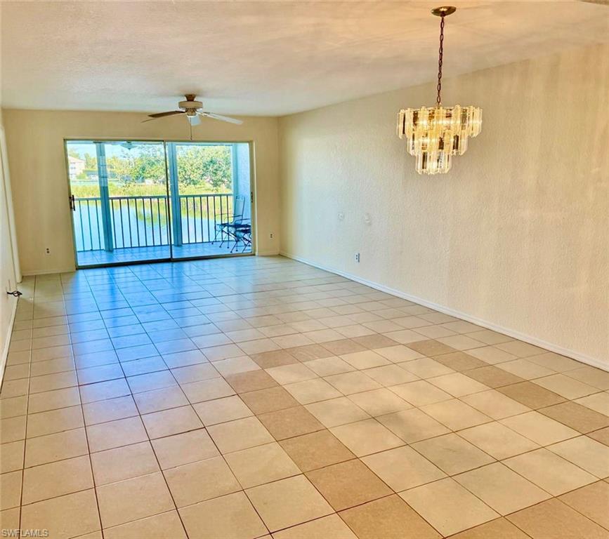 9580 Victoria Lane, Unit A202 Naples, FL 34109 - Photo 5 of 18 a view of an empty room with a window