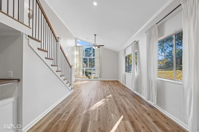 a view of entryway with wooden floor and stairs