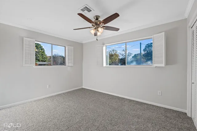 a view of a livingroom with a window and a ceiling fan