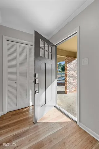 a view of a big room with wooden floor and windows