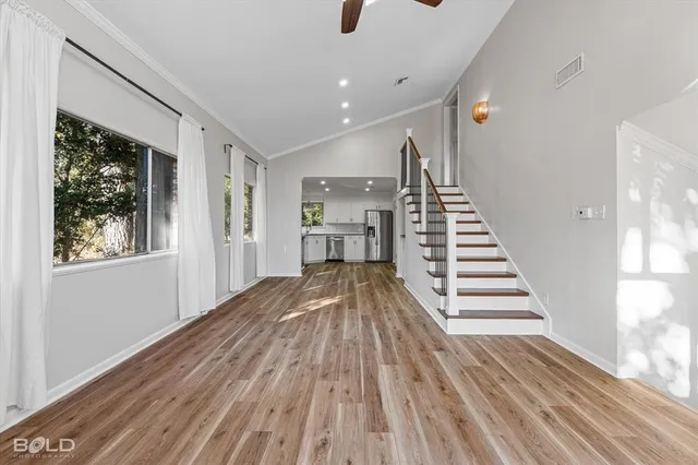 a view of a room with wooden floor and stairs