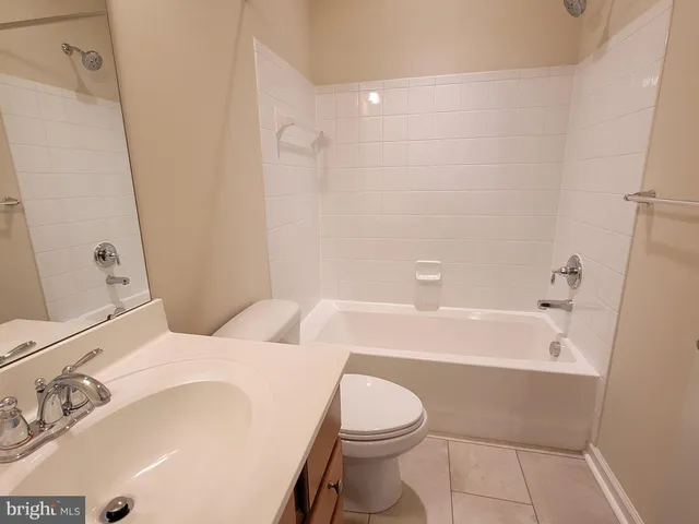 a bathroom with a sink a toilet and bathtub