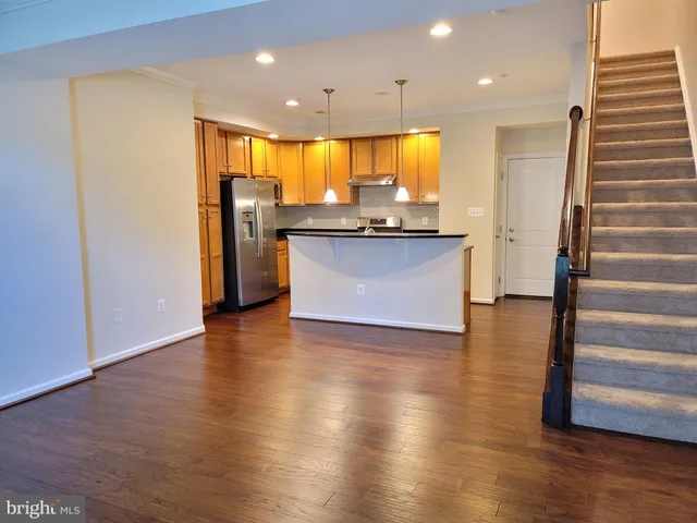 a view of kitchen with cabinets and wooden floor