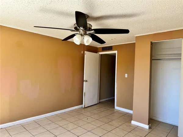 a view of a room with a hanging light and closet