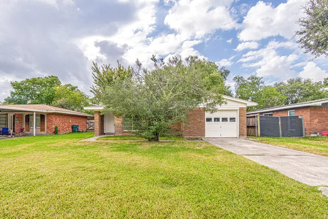 a view of a house with a yard and garage