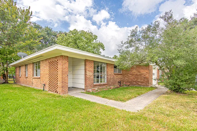 a view of a house with yard and a garden