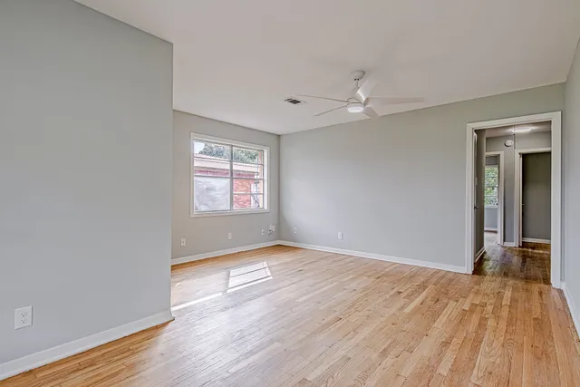wooden floor in an empty room with a window