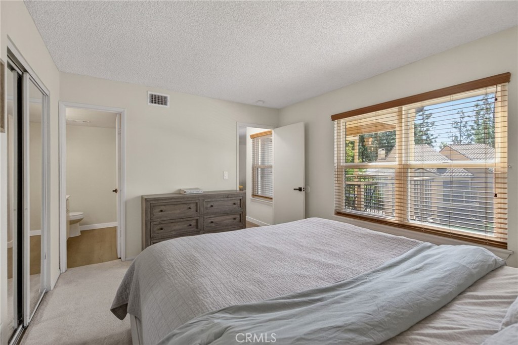 10655 Lemon Avenue, Unit 1304 Rancho Cucamonga, CA 91737 - Photo 12 of 38 a bedroom with a large bed and a large window