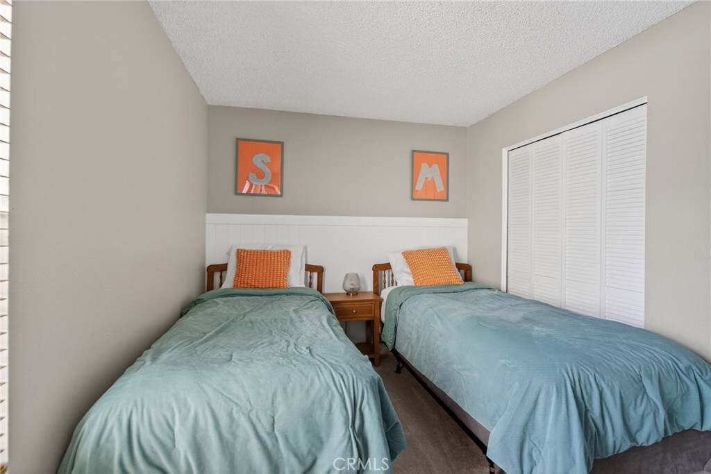 10655 Lemon Avenue, Unit 1304 Rancho Cucamonga, CA 91737 - Photo 15 of 38 a bedroom with two beds and a wooden floor