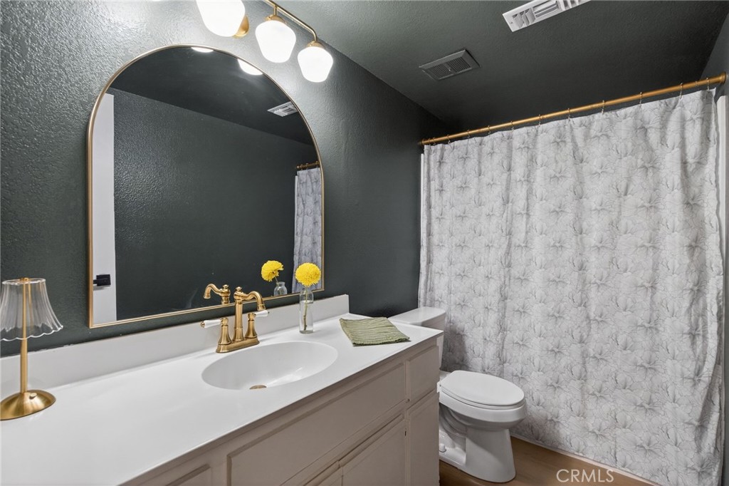 10655 Lemon Avenue, Unit 1304 Rancho Cucamonga, CA 91737 - Photo 16 of 38 a bathroom with a toilet sink and mirror