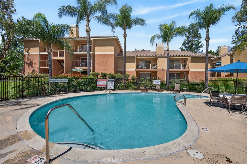 10655 Lemon Avenue, Unit 1304 Rancho Cucamonga, CA 91737 - Photo 28 of 38 front view of a house with swimming pool and patio