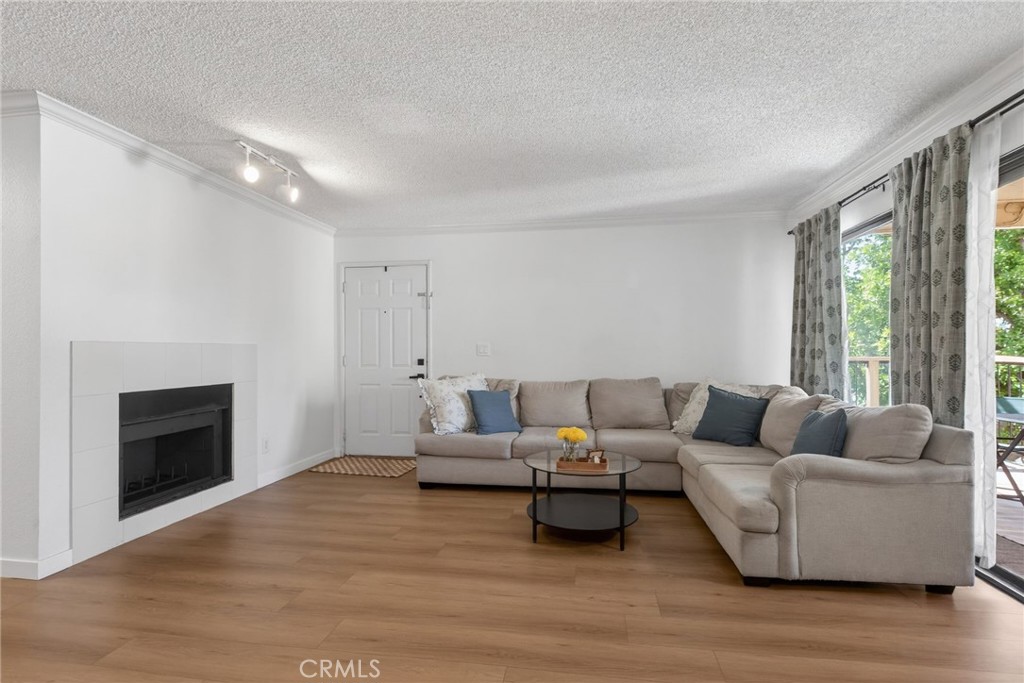 10655 Lemon Avenue, Unit 1304 Rancho Cucamonga, CA 91737 - Photo 3 of 38 a living room with furniture and a fireplace