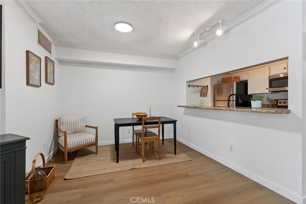 10655 Lemon Avenue, Unit 1304 Rancho Cucamonga, CA 91737 - Photo 5 of 38 a work room with furniture and a wooden floor