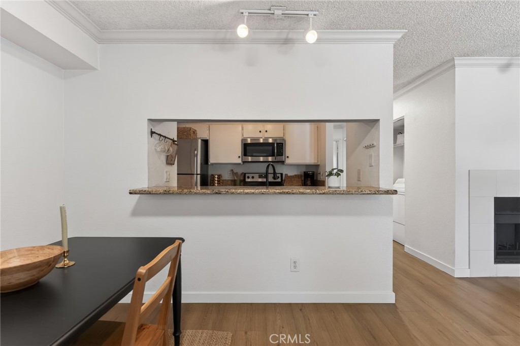 10655 Lemon Avenue, Unit 1304 Rancho Cucamonga, CA 91737 - Photo 6 of 38 a kitchen with a sink cabinets and wooden floor