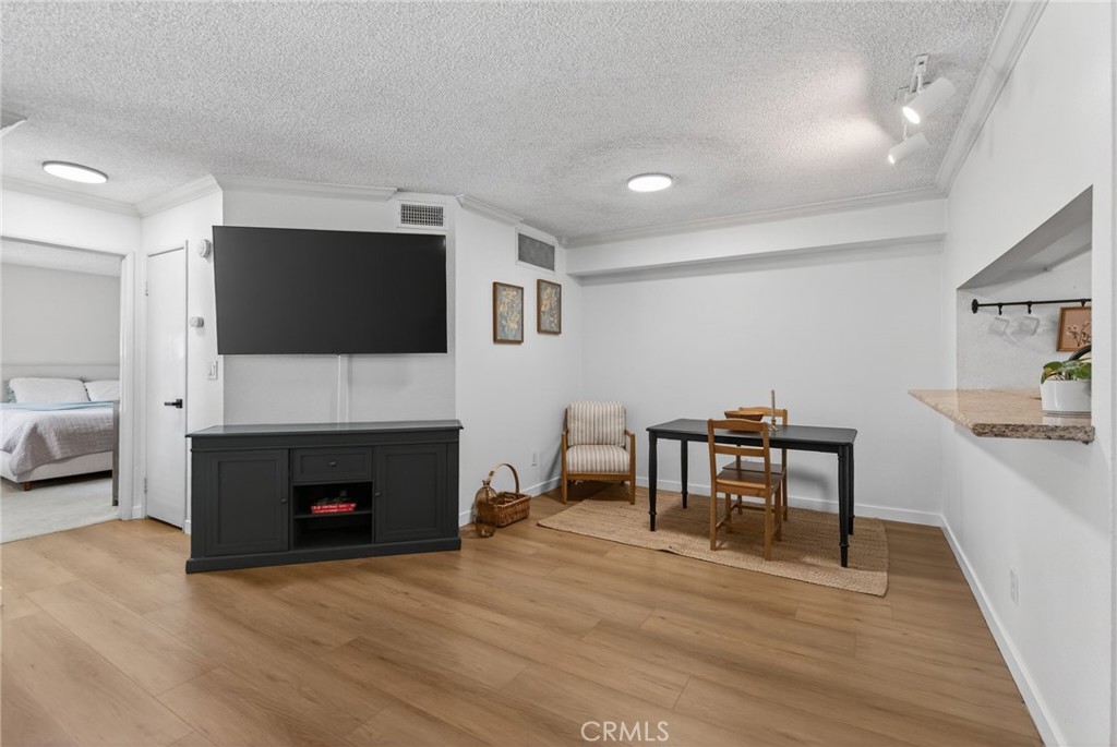 10655 Lemon Avenue, Unit 1304 Rancho Cucamonga, CA 91737 - Photo 7 of 38 a living room with furniture a fireplace and a flat screen tv