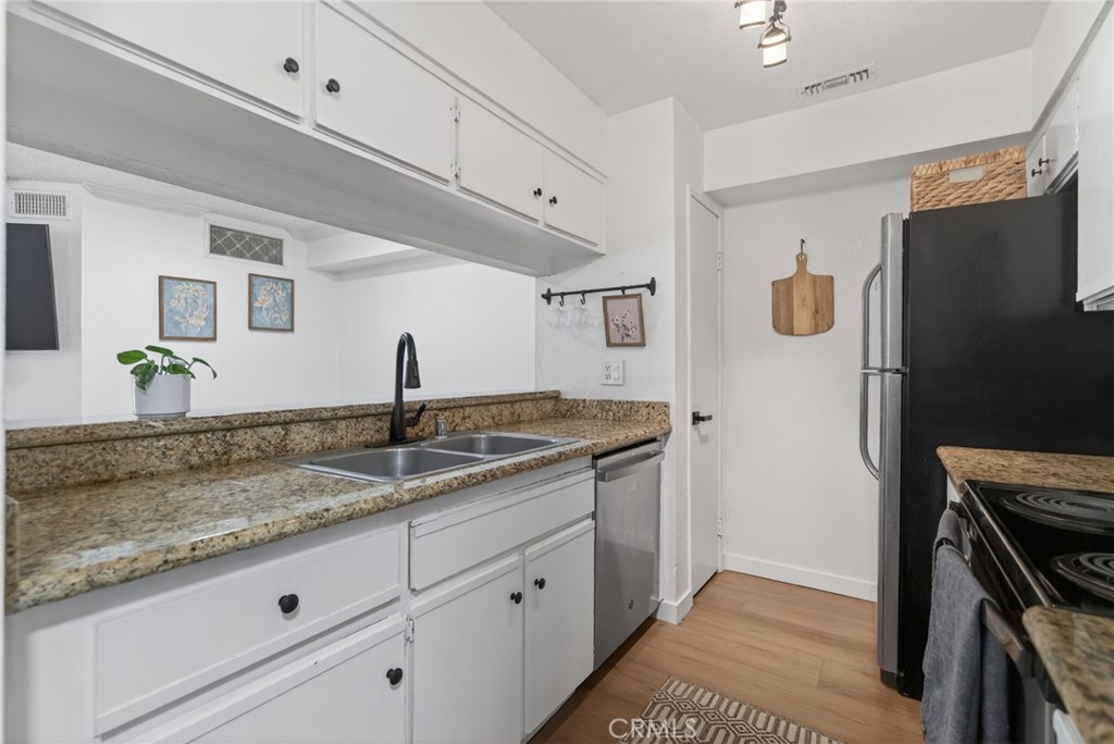 10655 Lemon Avenue, Unit 1304 Rancho Cucamonga, CA 91737 - Photo 8 of 38 a kitchen with a sink and a refrigerator