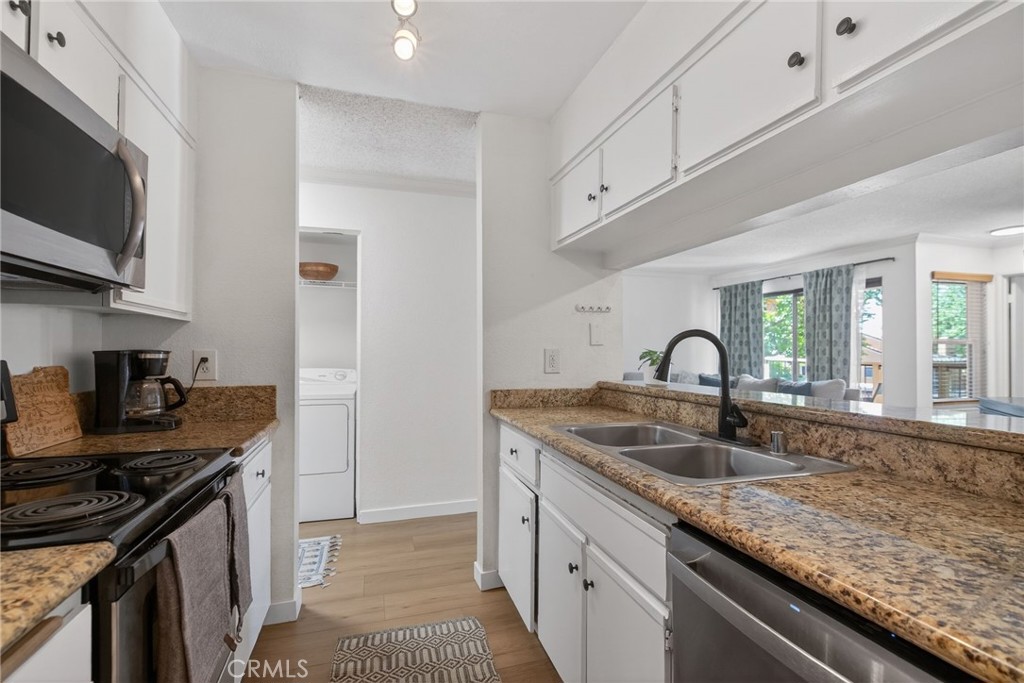 10655 Lemon Avenue, Unit 1304 Rancho Cucamonga, CA 91737 - Photo 10 of 38 a kitchen with granite countertop a sink stainless steel appliances and cabinets