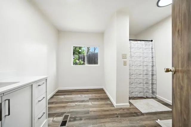 a view of a livingroom with wooden floor and a window