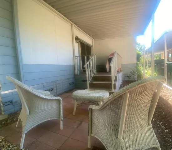 a balcony with table and chairs