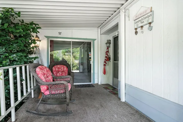 a view of a two chairs in the balcony