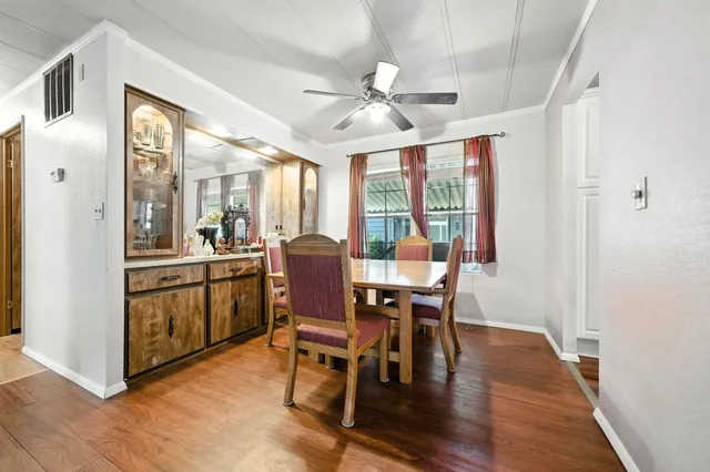 a view of a dining room with furniture window and wooden floor